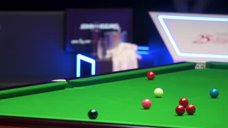 John-Higgins,-a-Scottish-professional-snooker-player,-plays-a-shot-as-he-strikes-a-ball-during-a-match-of-the-Hong-Kong-Masters-snooker-tournament-event