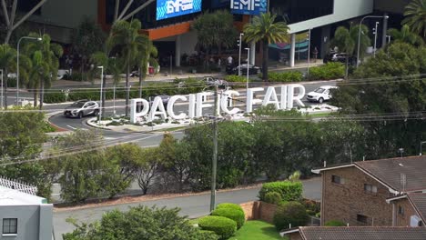 Time-lapse-close-up-shot-of-front-entrance-of-pacific-fairs-shopping-centre,-capturing-car-driving-at-the-gated-roundabout-exit-to-Hooker-Blvd,-Broadbeach,-Gold-Coast,-Queensland,-Australia