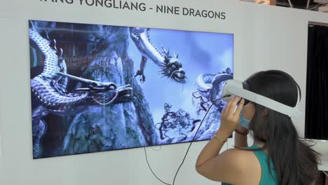 A-Chinese-art-enthusiast-uses-a-Virtual-Reality-headset-to-interact-with-an-immersive-artwork-at-the-Digital-Art-Fair-showcasing-upcoming-trends-such-as-Web-3