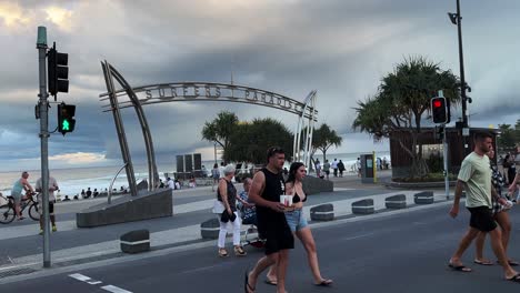Pedestrians-crossing-the-street,-strolling-on-along-the-esplanade-at-surfers-paradise,-Gold-Coast,-Queensland,-Australia