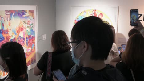 Chinese-visitors-use-augmented-reality-with-their-smartphones-to-interact-with-artworks-at-the-Digital-Art-Fair-Asia-showcasing-upcoming-trends-such-as-Web-3