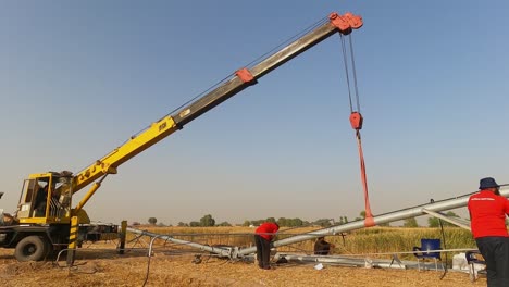 Timelapse-of-men-working-with-cranes-on-Pivot-Irrigation-System-in-Pakistan
