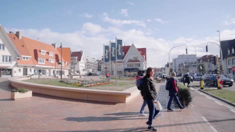People-walking-in-the-city-center-of-De-Haan,-Belgium