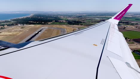 Third-part-of-passenger-point-of-view-of-Wizzair-aircraft-wing-during-take-off-from-Rome-Fiumicino-Airport-runway,-Italy