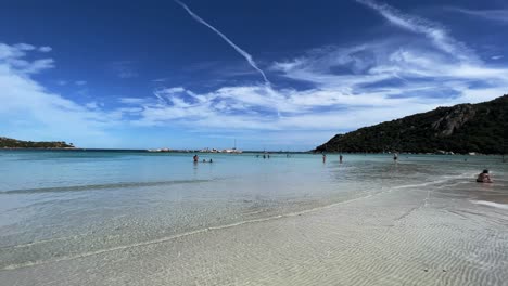 Santa-Giulia-Berühmter-Französischer-Korsischer-Himmlischer-Strand-Mit-Kristallklarem-Türkisfarbenem-Meerwasser-Und-Urlaubern,-Die-An-Heißen-Sommertagen-Ein-Bad-Nehmen