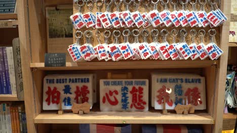 Traditional-Hong-Kong-art-souvenirs,-mini-bus-calligraphy-plates,-and-red-white-blue-plastic-bags