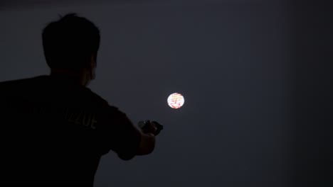 A-Chinese-visitor-uses-a-flashlight-to-interact-with-an-artwork-at-the-Digital-Art-Fair-showcasing-upcoming-trends-such-Web-3