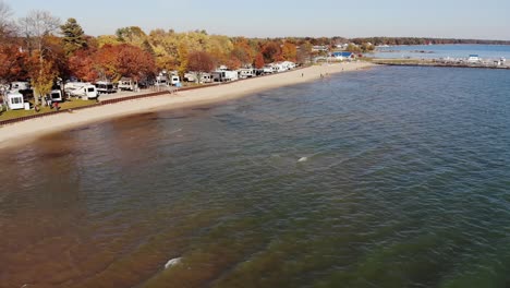 A-fall-aerial-view-of-a-trailer-park-on-the-shoreline-of-Lake-Huron-in-Tawas-City,-Michigan