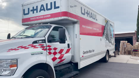 Large-U-Haul-truck-in-front-of-a-home-with-open-garage