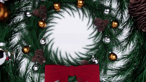 Christmas-fir-wreath-with-red-ribbon,-gold-and-silver-balls,-and-stone-pines,-on-white-glossy-background-3D-animation