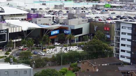 Front-entrance-of-pacific-fairs-shopping-centre-on-Hooker-Blvd,-static-shot-capturing-the-building-exterior-and-compact-parking-area-on-the-weekend,-Broadbeach,-Gold-Coast,-Queensland,-Australia