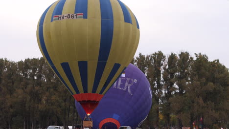 Der-Gelbe-Heißluftballon-Hebt-Während-Des-Festivals-Ab,-Während-Sein-Brenner-Die-Luft-Erhitzt