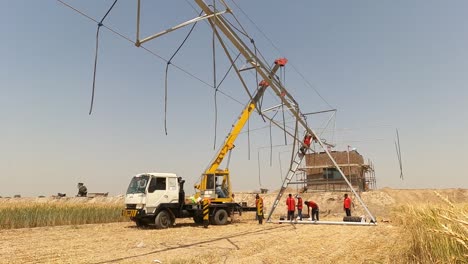Timelapse-of-group-of-men-constructing-the-Center-Pivot-Irrigation-System-in-Pakistan-in-a-summer-day