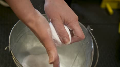 Man-coating-his-hand-with-chalk-powder