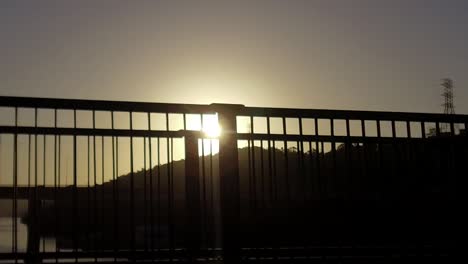 Driving-over-a-bridge-as-the-sun-sets