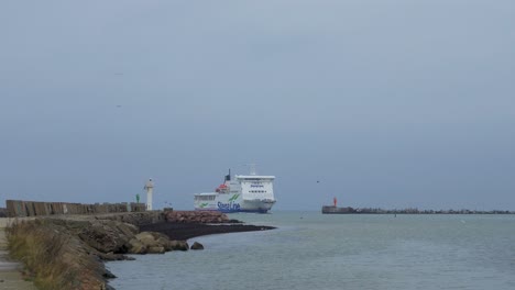 Big-ferry-ship-Stena-Line-arriving-at-Port-of-Liepaja-,-overcast-autumn-day,-distant-wide-shot