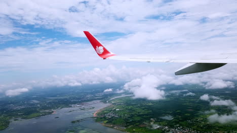 View-the-atmosphere-window-wing-of-a-Thai-Lion-Air-airplane-flight-in-sky-for-travel-transportation-on-holiday-at-Thailand