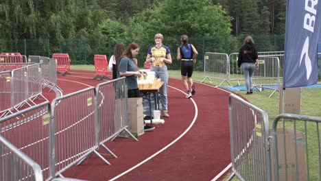 Female-marathon-runner-rejecting-offer-water-from-volunteers