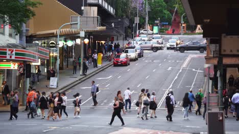 Crowd-of-people-crossing-at-the-intersection-between-Adelaide-and-Edward-Street-in-bustling-downtown-Brisbane-city,-central-business-district-during-off-work-rush-hours