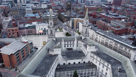 Aerial-Drone-Shot-flying-over-back-of-Leeds-Civic-Hall-looking-in-to-Leeds-City-Centre-and-Leeds-Town-Hall-on-a-cloudy-day