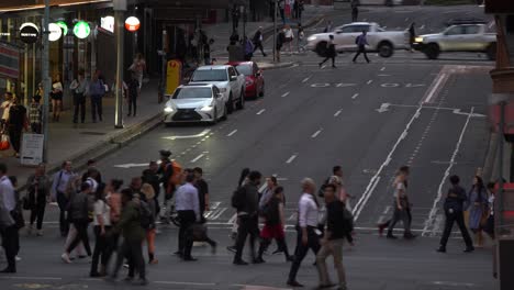 Large-crowd-of-people-crossing-at-the-intersection-between-Adelaide-and-Edward-Street-in-bustling-downtown-Brisbane-city,-central-business-district-during-off-work-rush-hours