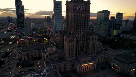 Epic-aerial-view-of-the-Palace-of-culture-of-Warsaw-at-dusk,-Poland