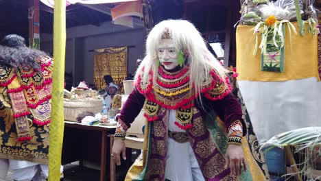Topeng-Tua-Balinese-Dance-Show,-Blonde-Haired,-Old-Man-Mask-Performance-in-Bali-Indonesia,-Family-Hindu-Temple-Celebration,-Magical-Character-in-Fashionable-Costume