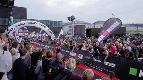 Slow-motion-tripod-shot-of-woman-finishing-the-KMD-Ironman-Copenhagen-2018-with-people-cheering