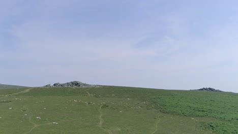 Wide-shot-of-two-tors-in-the-distance-on-Dartmoor,-England