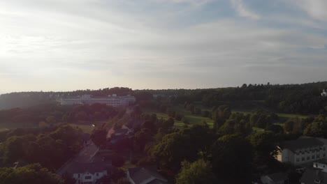 Distant-aerial-view-filmed-near-dusk-of-the-Grand-Hotel-on-Mackinac-Island,-Michigan