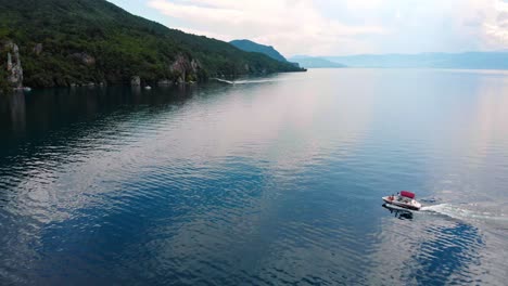 Aerial-shot-of-Macedonia-coast-and-boat-entering-a-bay