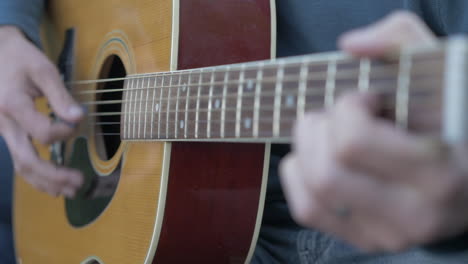 Man-Playing-a-Guitar-Outside,-Extreme-Close-up-and-Shallow-Depth-of-Field