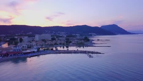 Greece,-Corfu-Island,-drone-footage-of-a-beautiful-sunset-over-Messonghi-Beach