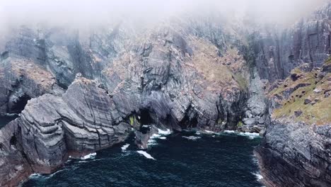 Mizen-Head,-Ireland,-dramatic-drone-shots-of-the-cliffs-on-a-misty-day