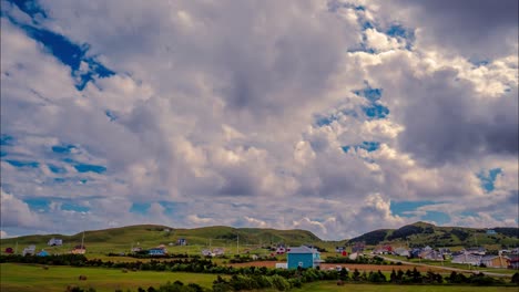 Amazing-time-lapse-of-blue-sky-and-bright-white-clouds-blowing-over-a-quaint-village-in-the-Magdalen-Islands