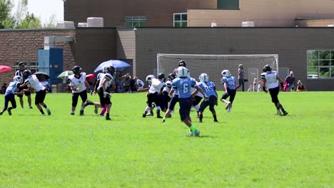 Youth-12-year-old-American-football-league-quarterback-completes-a-short-pass