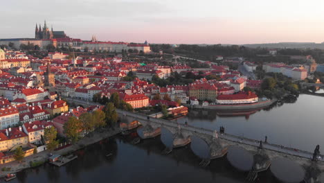 Aerial-view-to-Vltava-river,-Charles-bridge-and-Prague-castle-at-sunrise,-Prague,-Czech-Republic