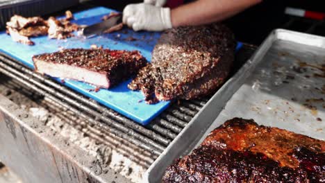 BBQ-grill-chef-carves-smoked-beef-brisket