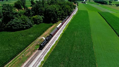 Steam-Train-at-Picnic-Area,-Dropping-off-Passengers-in-Amish-Countryside-as-seen-by-Drone