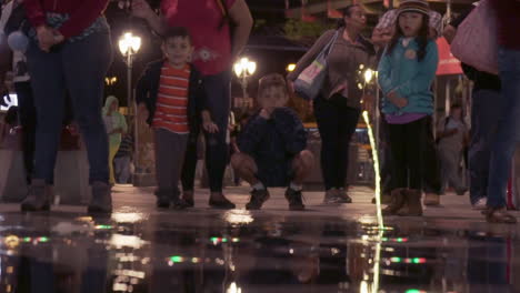 Slowmotion-of-happy-kids-playing-with-water-jets-in-the-streets-of-San-Jose