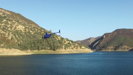 A-helicopter-circles-above-a-pristine-mountain-lake