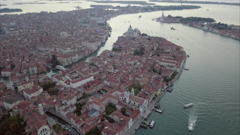 Aerial-revealing-shot-Flying-towards-San-Marco-over-Canal-Grande-at-dusk,-Venice,-Italy