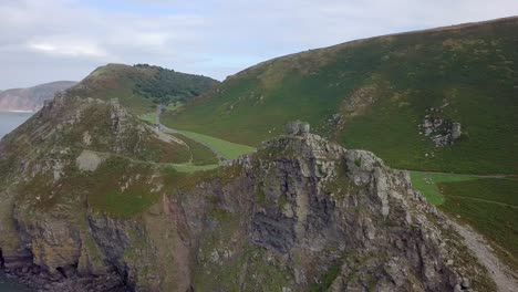 Wide-aerial-panning-and-tracking-from-right-to-left-around-the-Valley-of-Rocks,-near-Lynton,-Devon