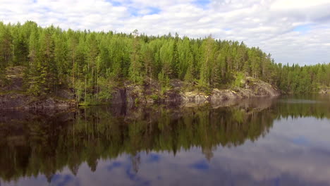 Tranquil-lake-with-sky-reflections-in-the-boreal-wilderness-of-Finland