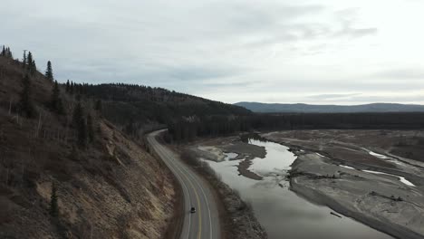 Aerial-view-of-road-next-to-river-in-Alaska