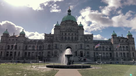 Speed-up-walk-towards-fountain-in-front-of-Victoria-parliament,-sunny-day