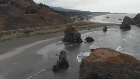 Aerial-showing-gentle-waves-lapping-up-onto-the-beach-in-Oregon