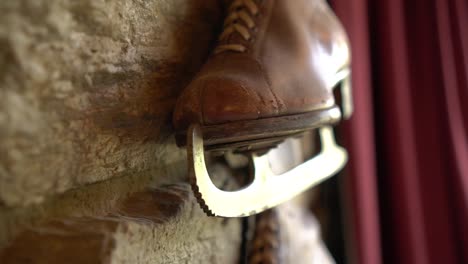 Old-brown-leather-antique-ice-skating-shoe-on-historic-wall