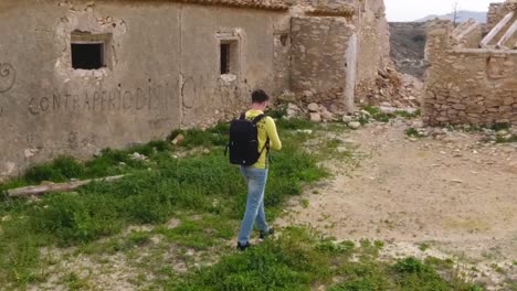 Young-man-exploring-old-ruins-and-taking-photo-in-slow-motion