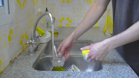 Male-person-doing-dishes-at-home